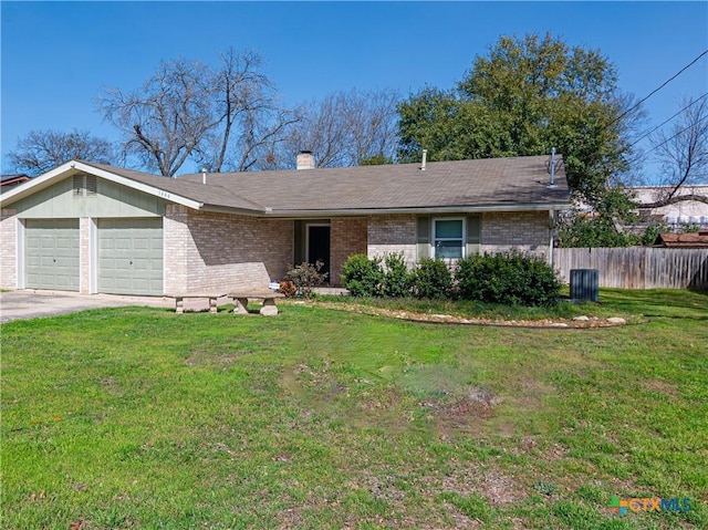 ranch-style house with a garage, a front yard, and brick siding