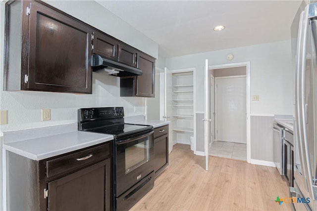 kitchen with light wood finished floors, light countertops, dark brown cabinetry, under cabinet range hood, and black / electric stove