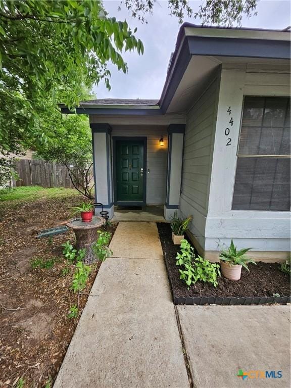 view of exterior entry with fence