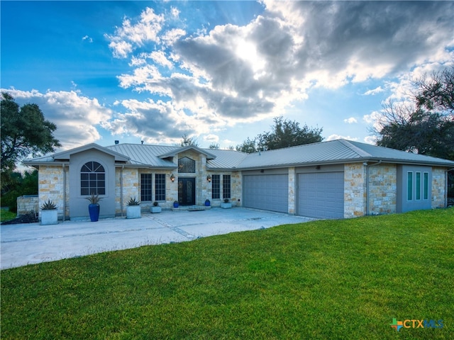 ranch-style home with a garage and a front lawn