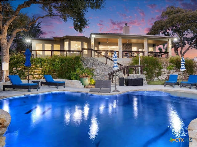 view of pool at dusk