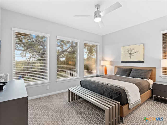 bedroom featuring ceiling fan and light carpet