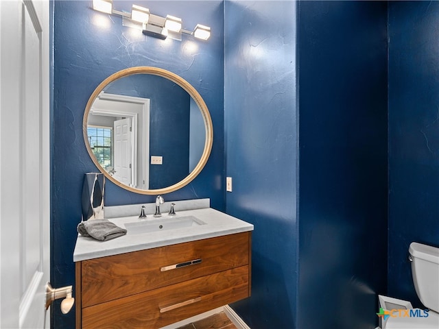 bathroom with vanity and toilet