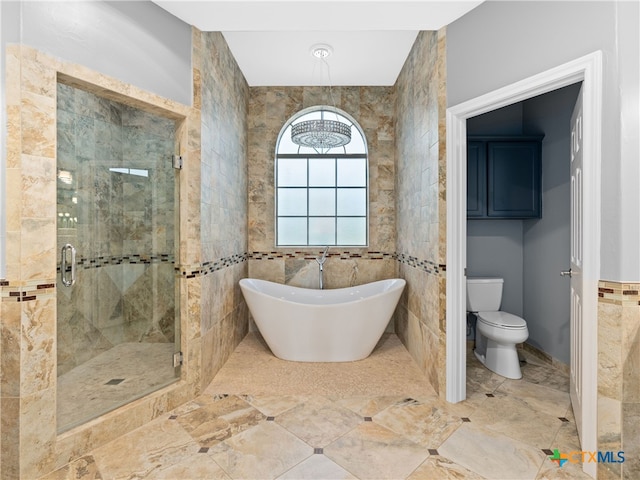 bathroom with toilet, tile walls, and plus walk in shower