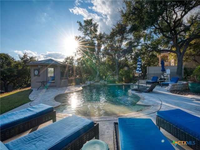 view of swimming pool with a patio and an outdoor structure