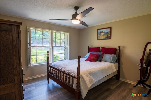 bedroom featuring ceiling fan, dark hardwood / wood-style floors, a textured ceiling, and ornamental molding