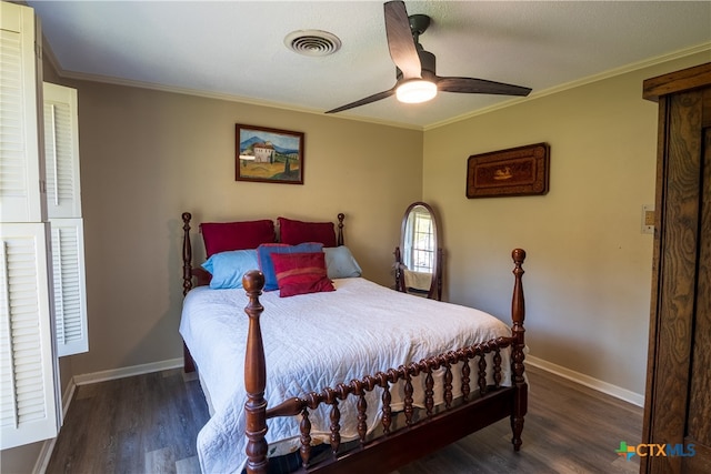 bedroom featuring dark wood-type flooring, ornamental molding, and ceiling fan