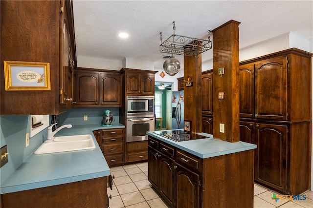 kitchen featuring stainless steel appliances, dark brown cabinets, a textured ceiling, and sink