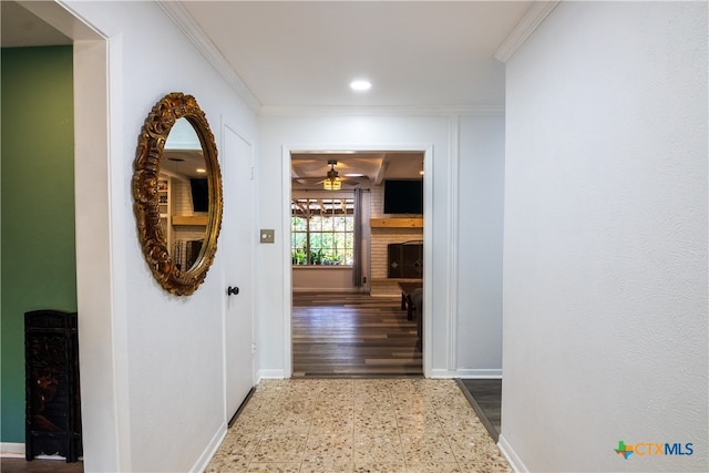 hallway with hardwood / wood-style floors and crown molding