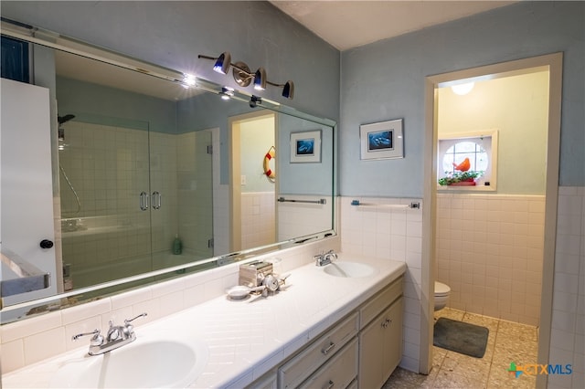 bathroom with walk in shower, vanity, toilet, and tile walls