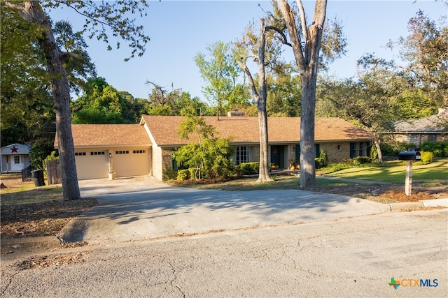 single story home featuring a garage and a front yard