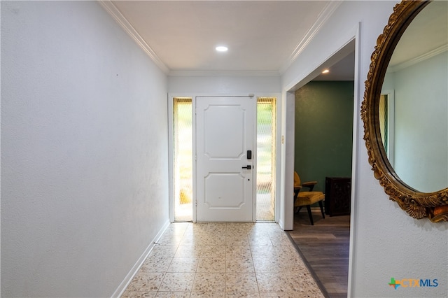 foyer with wood-type flooring and ornamental molding