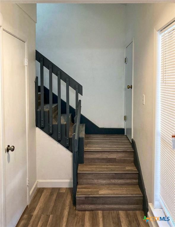 195 Gallagher Dr Unit 18, Canyon Lake, TX 78133 - stairway with baseboards and wood finished floors