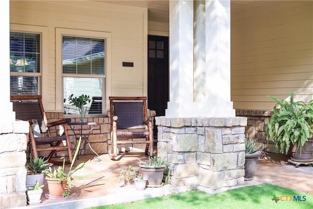 view of exterior entry featuring a porch