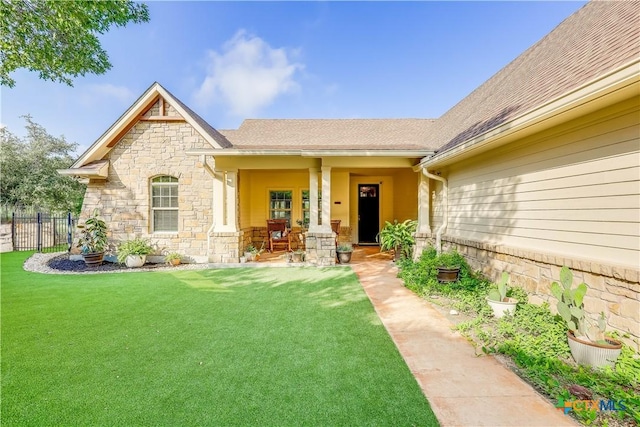 entrance to property with a lawn and a porch