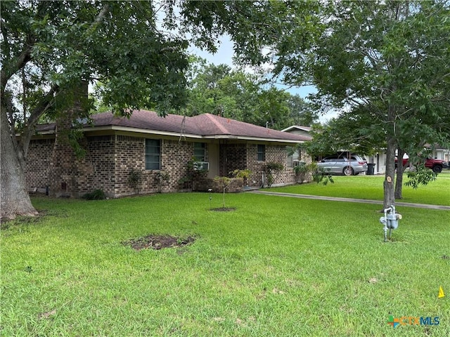302 E Heard St, Ganado, TX 77962 - ranch-style house with a front lawn and brick siding
