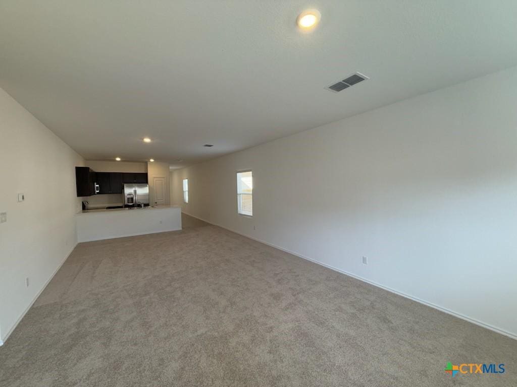 unfurnished living room with carpet floors