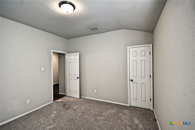 475 Autumn Leaf Dr, New Braunfels, TX 78130 - unfurnished bedroom with lofted ceiling, carpet, and a textured ceiling