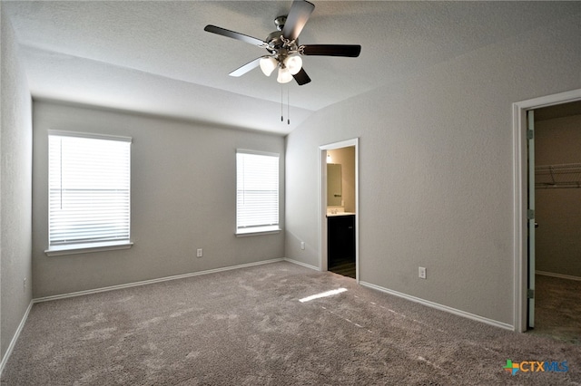 475 Autumn Leaf Dr, New Braunfels, TX 78130 - unfurnished bedroom with a spacious closet, carpet floors, connected bathroom, a closet, and a ceiling fan