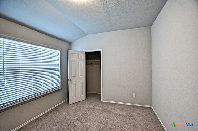 475 Autumn Leaf Dr, New Braunfels, TX 78130 - unfurnished bedroom featuring vaulted ceiling, carpet flooring, a closet, and a textured ceiling
