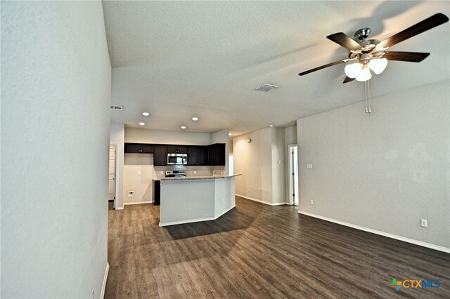 475 Autumn Leaf Dr, New Braunfels, TX 78130 - kitchen with stainless steel microwave, dark wood-style floors, open floor plan, ceiling fan, and recessed lighting