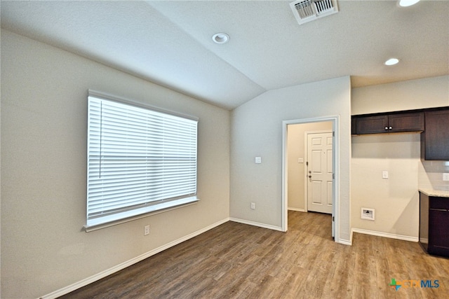 475 Autumn Leaf Dr, New Braunfels, TX 78130 - unfurnished living room featuring wood finished floors, recessed lighting, and vaulted ceiling