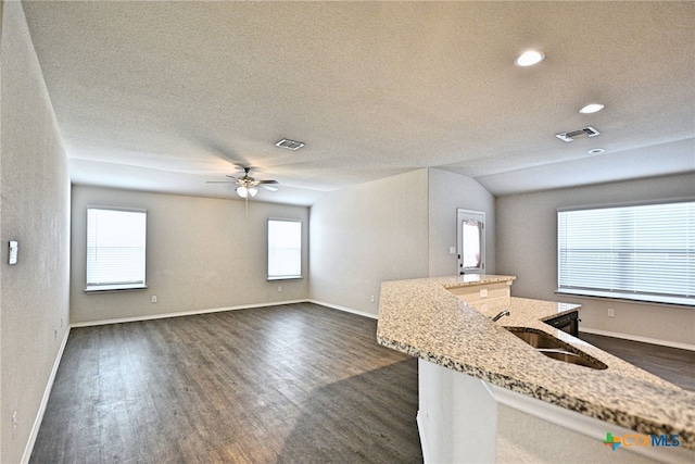 475 Autumn Leaf Dr, New Braunfels, TX 78130 - unfurnished living room featuring dark wood-style flooring, a ceiling fan, a textured ceiling, and recessed lighting