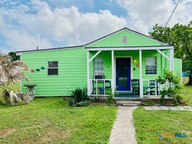 bungalow-style home featuring a front yard and covered porch