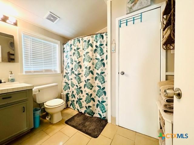 bathroom with vanity, tile patterned floors, and toilet