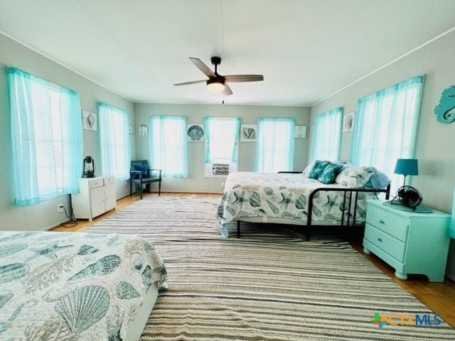 bedroom with hardwood / wood-style floors and ceiling fan