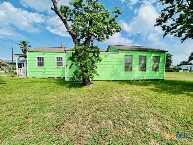 rear view of house with a yard