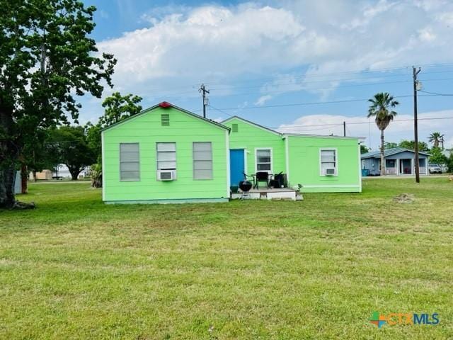 rear view of house with a lawn