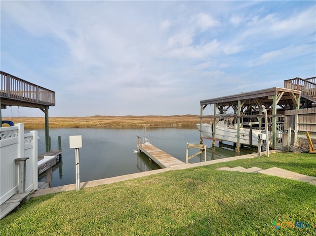 view of dock featuring a yard and a water view