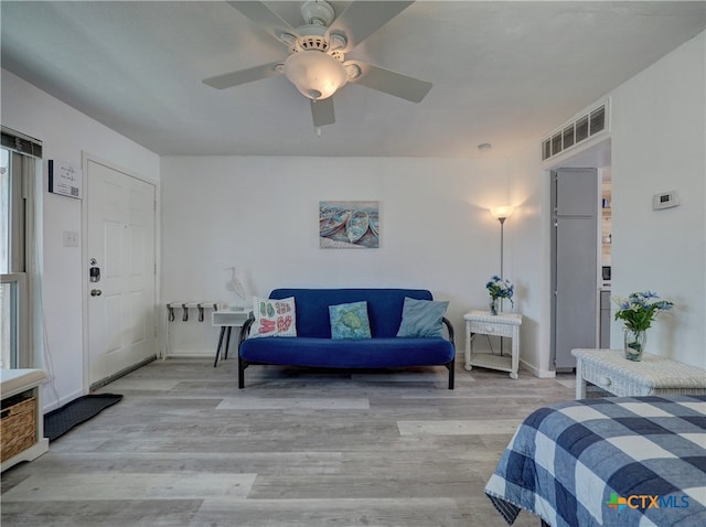 bedroom with light hardwood / wood-style floors and ceiling fan