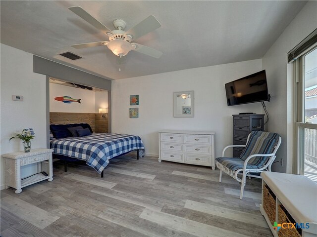 bedroom with light hardwood / wood-style flooring and ceiling fan