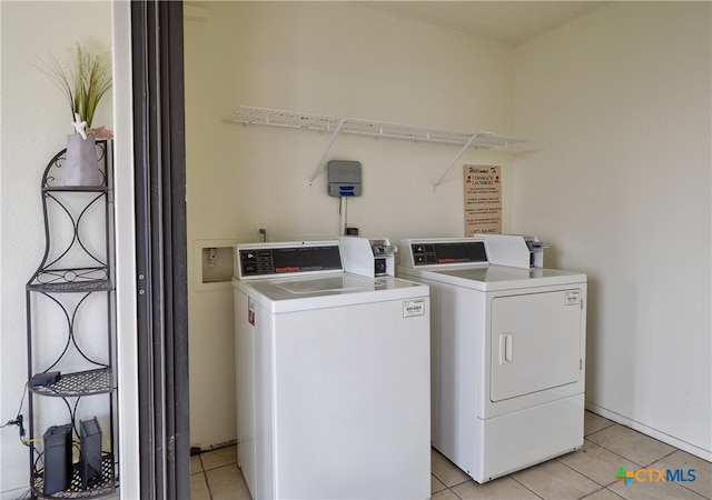 washroom with light tile patterned flooring and washing machine and dryer