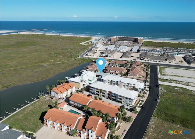 drone / aerial view with a beach view and a water view