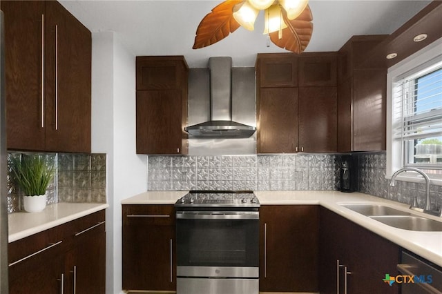 118 Byron Ln, Victoria, TX 77901 - kitchen with stainless steel appliances, wall chimney range hood, light countertops, and dark brown cabinets