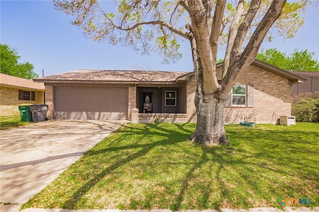 118 Byron Ln, Victoria, TX 77901 - ranch-style home featuring brick siding, a garage, concrete driveway, and a front yard