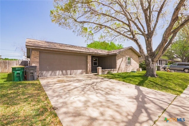 118 Byron Ln, Victoria, TX 77901 - ranch-style home with brick siding, driveway, and a garage