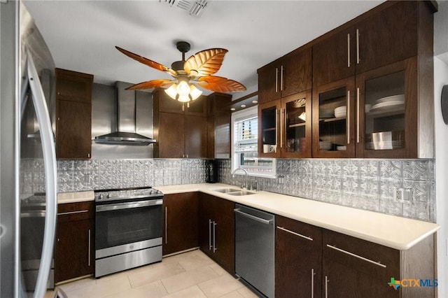 118 Byron Ln, Victoria, TX 77901 - kitchen featuring appliances with stainless steel finishes, wall chimney range hood, dark brown cabinets, and light countertops