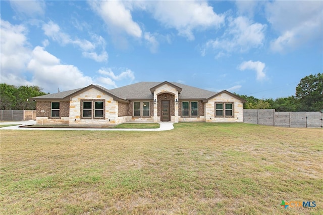 single story home featuring a front lawn