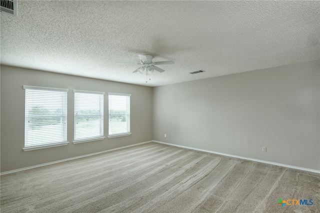 1335 Lakeside Loop, Round Rock, TX 78665 - spare room featuring ceiling fan, light carpet, and a textured ceiling