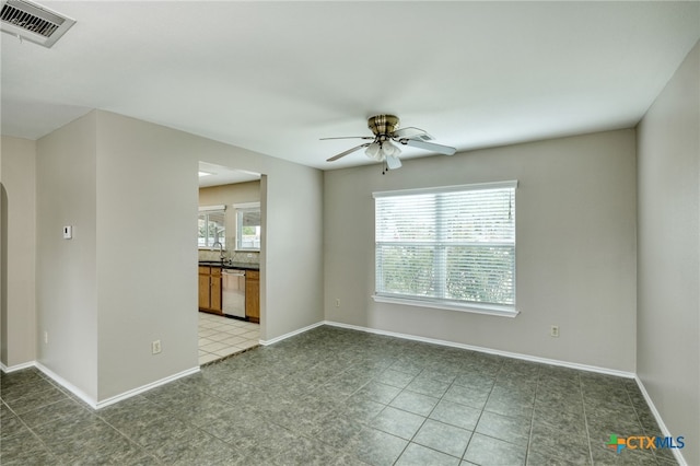 1335 Lakeside Loop, Round Rock, TX 78665 - tiled empty room with a ceiling fan and arched walkways