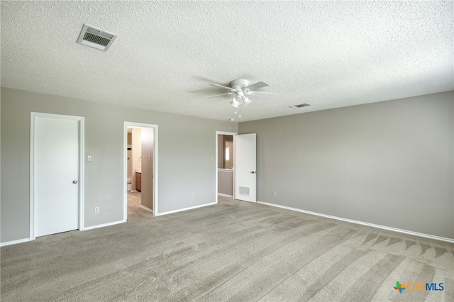 1335 Lakeside Loop, Round Rock, TX 78665 - unfurnished bedroom with carpet flooring, a textured ceiling, and a ceiling fan