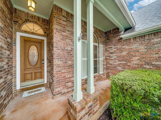 2615 Foresthaven Dr, New Braunfels, TX 78132 - property entrance featuring brick siding, roof with shingles, and a porch