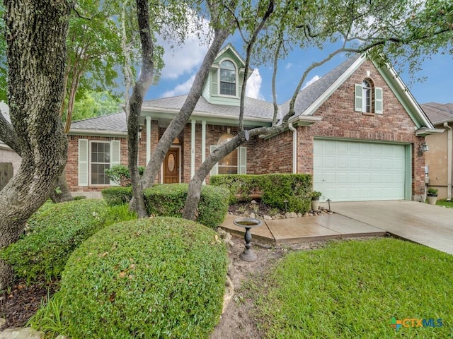 2615 Foresthaven Dr, New Braunfels, TX 78132 - traditional home with driveway, a shingled roof, and brick siding