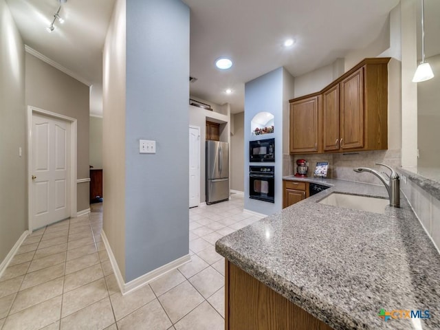 2615 Foresthaven Dr, New Braunfels, TX 78132 - kitchen featuring black appliances, a sink, light tile patterned floors, brown cabinetry, and light stone countertops