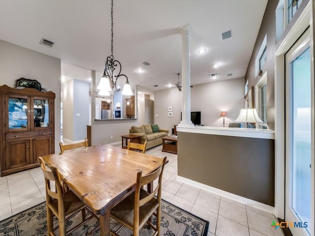 2615 Foresthaven Dr, New Braunfels, TX 78132 - dining room featuring decorative columns, light tile patterned floors, and a chandelier