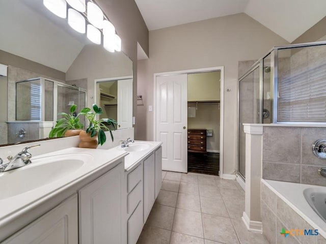 2615 Foresthaven Dr, New Braunfels, TX 78132 - bathroom with vaulted ceiling, a stall shower, a walk in closet, tile patterned floors, and a garden tub